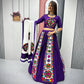 Woman wearing a purple Navratri lehenga with colorful Gamthi embroidery, holding a white dupatta with matching mirror work.