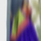 A girl showcasing a colorful lehenga in front of a mirror, wearing a vibrant ensemble with intricate designs.