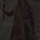 A woman dressed in a stunning maroon designer lehenga gracefully swirls, showcasing the outfit's elegant 4-meter flair. The lehenga features intricate mirror work, a canvas patta border, and vibrant traditional prints. As she twirls, the rich fabric and detailed craftsmanship are highlighted, making it a perfect attire for festive occasions like Navratri and weddings.