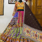 A beautifully designed Gujarati-style Lehenga Choli displayed on a mannequin, featuring intricate embroidery, vibrant patchwork, mirror embellishments, and a rich brown dupatta, perfect for Navratri and festive occasions.
